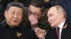Russian President Vladimir Putin and Chinese leader Xi Jinping talk as they watch the Victory Day military parade in Moscow in May 2025. 