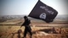 Iraq -- An image grab taken from a video uploaded on YouTube on August 23, 2013 allegedly shows a member of Ussud Al-Anbar (Anbar Lions), a Jihadist group affiliated to the Islamic State of Iraq and the Levant (ISIL), Al-Qaeda's front group in Iraq, hold