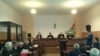 Суд под председательством Романа Кварчия рассматривает это дело с 5 ноября 2013 года. Обвиняемых – девять человек, их интересы защищают десять адвокатов, еще двое – в розыске