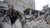 SYRIA -- A Syrian man mourns over his destroyed home in the rebel-held besieged town of Arbin, in the eastern Ghouta region on the outskirts of the capital Damascus, February 5, 2018