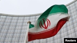 Austria -- An Iranian flag flutters in front of the International Atomic Energy Agency (IAEA) headquarters in Vienna, January 15, 2016