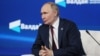 In this pool photograph distributed by the Russian state agency Sputnik, Russia's President Vladimir Putin attends the Valdai Discussion Club meeting in Sochi on October 2, 2025. (Photo by Mikhail METZEL / POOL / AFP)
